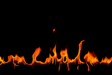 Fire flames on Abstract art black background, Burning red hot sparks rise, Fiery orange glowing flying particlesの写真素材