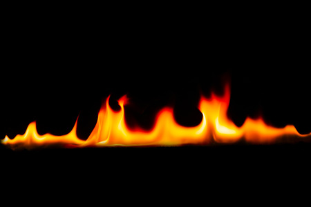 Fire flames on Abstract art black background, Burning red hot sparks rise, Fiery orange glowing flying particlesの写真素材