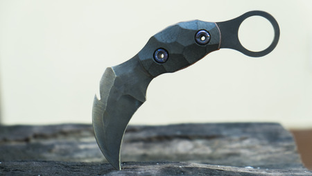 Knife in the hands, karambit knife tactical fighter, self defense Martial Arts Fighting