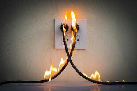 On fire electric wire plug Receptacle wall partition,Electric short circuit failure resulting in electricity wire burntの写真素材