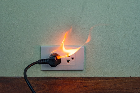 On fire electric wire plug Receptacle wall partition,Electric short circuit failure resulting in electricity wire burntの写真素材