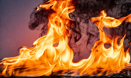 Fire flames on Abstract art black background, Burning red hot sparks rise, Fiery orange glowing...