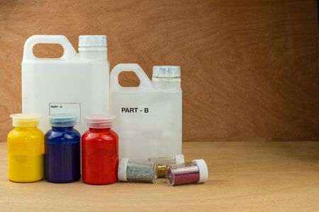 Mixing color epoxy resin in plastic cup for casting Stabilizing wood and pine cone hybrid
