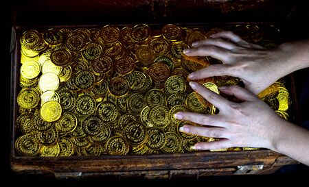 Stacking Gold Coin in treasure chest  on black background