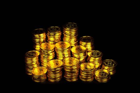 Stacking gold coin in treasure stack at black backgroundの写真素材