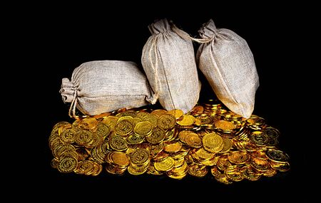 Stacking gold coin in treasure stack at black backgroundの写真素材