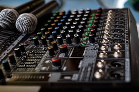 Microphone and audio sound mixer analog at the sound control room on blurred background