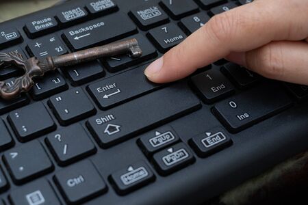 Close up female Index finger push button Enter on the computer keyboard, Data protection by key...