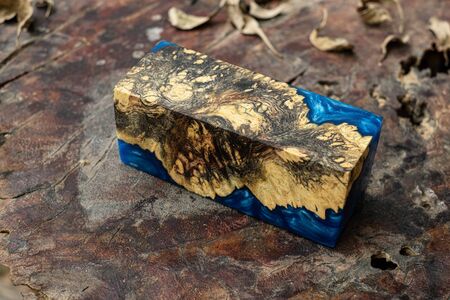 Casting blue epoxy resin burl wood cube on old table art background, Nature Afzelia woodenの写真素材