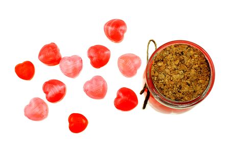 Red heart shaped lollipops together in glass bottle on white background, Valentine's Day concept conceptの写真素材