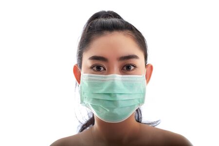 Beautiful young Asia woman putting on a medical mask to protect from airborne respiratory diseases as the flu covid-19 PM2.5 dust and smog, Women safety virus infection conceptの写真素材