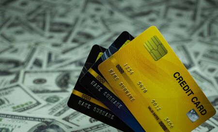 Close up credit card isolated at the stack of money banknote 100 USD background