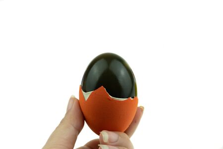 Century egg or preserved egg is eggs that are soaked in quicklime which turns the albumen green or black with Asian traditional food made by duck chicken or quail eggsの写真素材