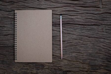 Pencil and book mockup on the old wood desk at the background, Flat lay photo, top viewの写真素材