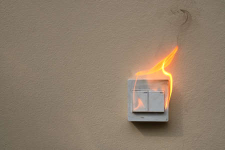On fire switch electric shock on concrete wallの写真素材