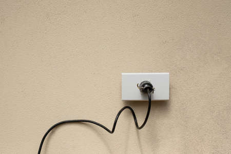 Electric wire plug Receptacle on the concrete wall backgroundの写真素材