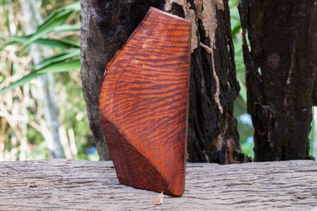 Natural Burma padauk wood has tiger stripe or curly stripe grain on the table