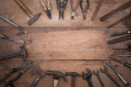 Collection of antique woodworking handtools on a rough workbench old wooden with blank copy space