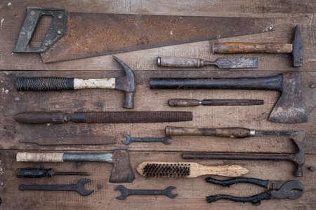 Collection of antique woodworking handtools on a rough workbench old woodenの写真素材