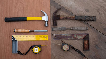 Hamer chisel Tape measure Ruler Collection of old and new woodworking handtools on a rough workbench...