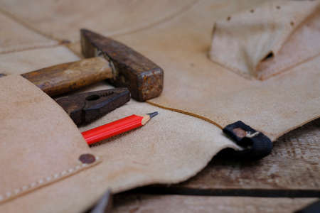 Collection of woodworking old hand tools in leather apron on a rough workbench woodenの写真素材