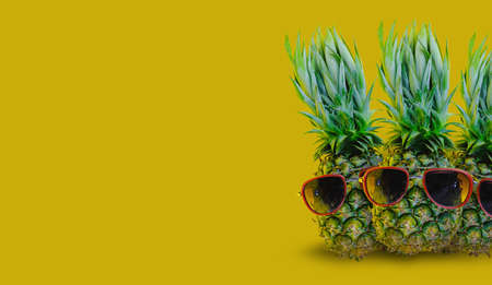 3 Pineapple wearing red sunglasses on isolated yellow background, minimal concept