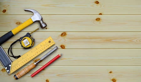 Hammer tape measure try square pen and chisel collection of woodworking handtools on a workbench...