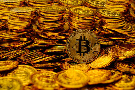 Bitcoin cryptocurrency on pile gold coins a lot ofの写真素材
