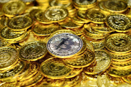 Golden bitcoin cryptocurrency on pile gold coins a lot of