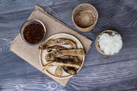 Slice buffalo buff grilled for food with cooked sticky rice, Animal  leather that has been dried...