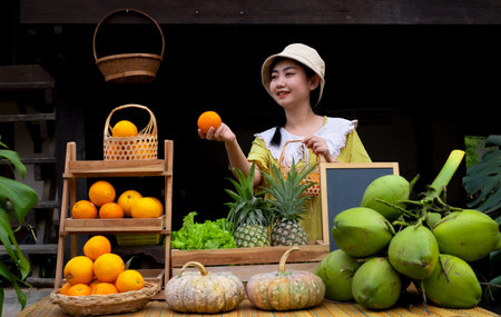 Asia woman selling a natural variety of fruits at the farm stayの写真素材