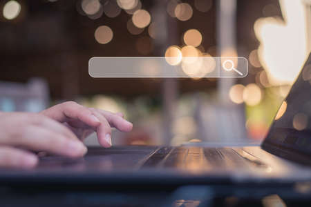 Business man using laptop, searching web, browsing information, having workplace at home or cafe.の写真素材