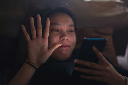 Young happy woman using mobile phone for video call , gesturing hi to friends, relatives or parents....