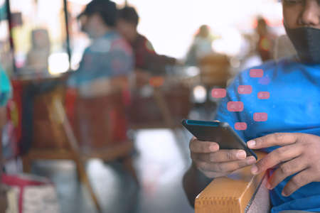 Person using a social media marketing concept on mobile phone with notification icons of like,...