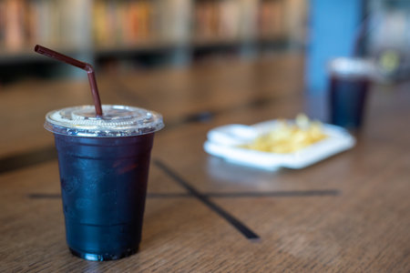 Americano ice coffee  in abandoned food court during social distancing measures in Coronavirus pandemicの写真素材