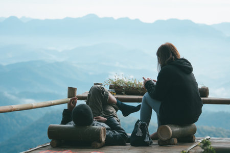 Happy couple lying on terrace coffee shop while resting on top of a mountain.の写真素材