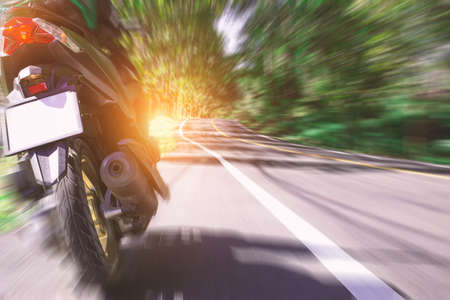 motorbike on the road riding. having fun driving the empty road on a motorcycle tour journey. copys pace for text.の写真素材