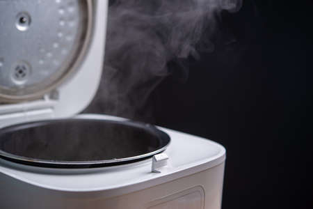 Smoke from the rice cooker, rice cooker in the kitchen, steam from the rice cooker, copy space for text.の写真素材