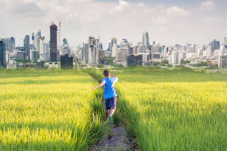 happy  boy running to the urban city, life concept.の写真素材