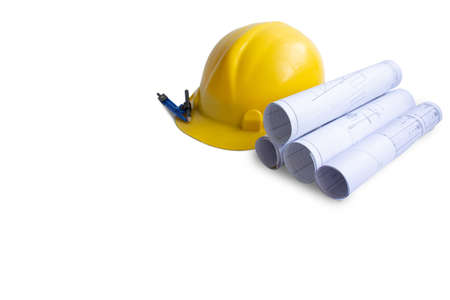 Yellow construction helmet with blueprint and pencil , engineer safety concept, copy space for text.