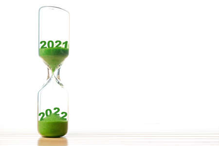 New Year 2022 concept with hourglass falling sand taking the shape of a 2022, copy space for text.の写真素材