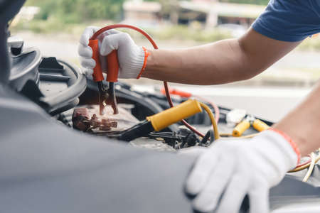 Charging battery car with electricity trough jumper cables.の写真素材