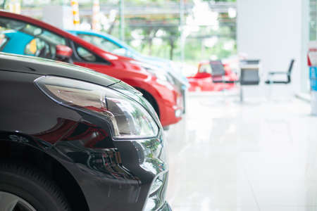 Modern beautiful showroom with cars being sold, White floor for new car parking, new car pictures in the showroom, park, show waiting for sales of branch dealers and new car service centers.の写真素材