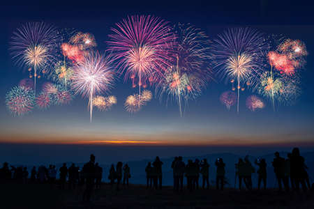 Crowd watching fireworks and celebrating, Friends are happy, looks holiday fireworks, people having...