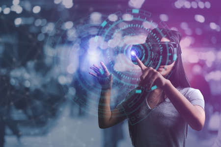Metaverse digital cyber world technology, woman with virtual reality VR goggle playing AR augmented reality game and entertainment, futuristic lifestyleの写真素材