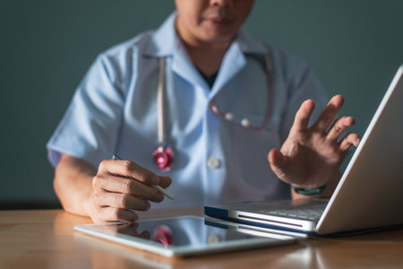 Male professional online doctor wearing headset speaking looking at camera consulting patient in...