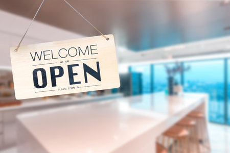 Wooden sign board hanging on door of cafe,Come in we're open, vintage black retro sign in blurred...