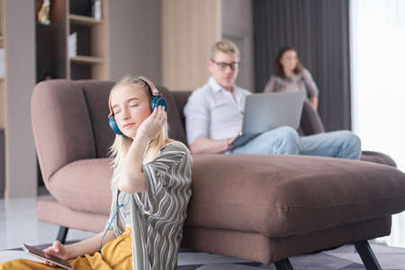 Caucasian family sitting on the internet in the living room of a vacation home.