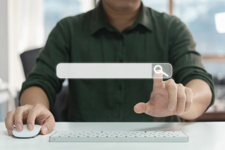 Searching Browsing Internet Data Information with blank search bar. man's hands are using a computer keyboard to Searching for information. Using Search Console with your website.の写真素材