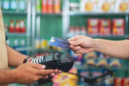 Customer using credit card for payment to owner at cafe restaurant, cashless technology and credit...